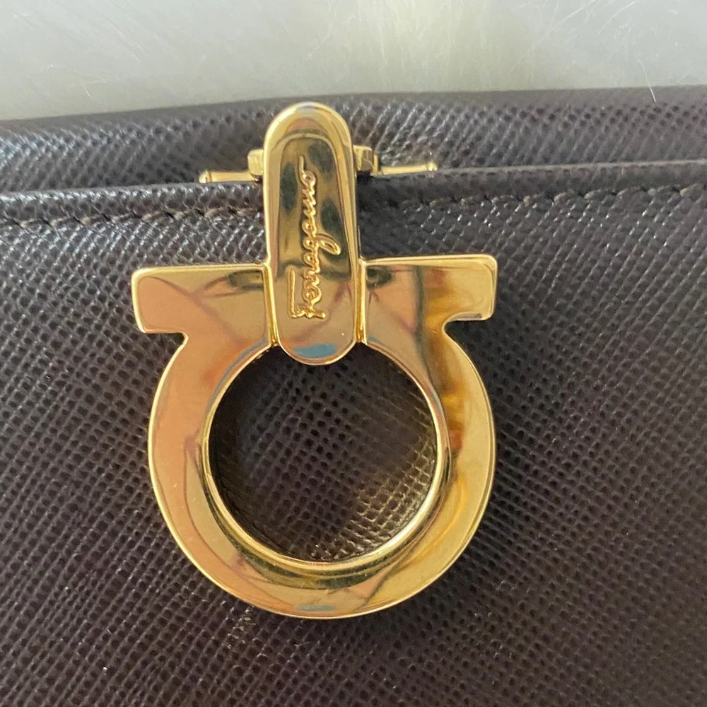 Salvatore Ferragamo Deep brown leather wallet with gold accent