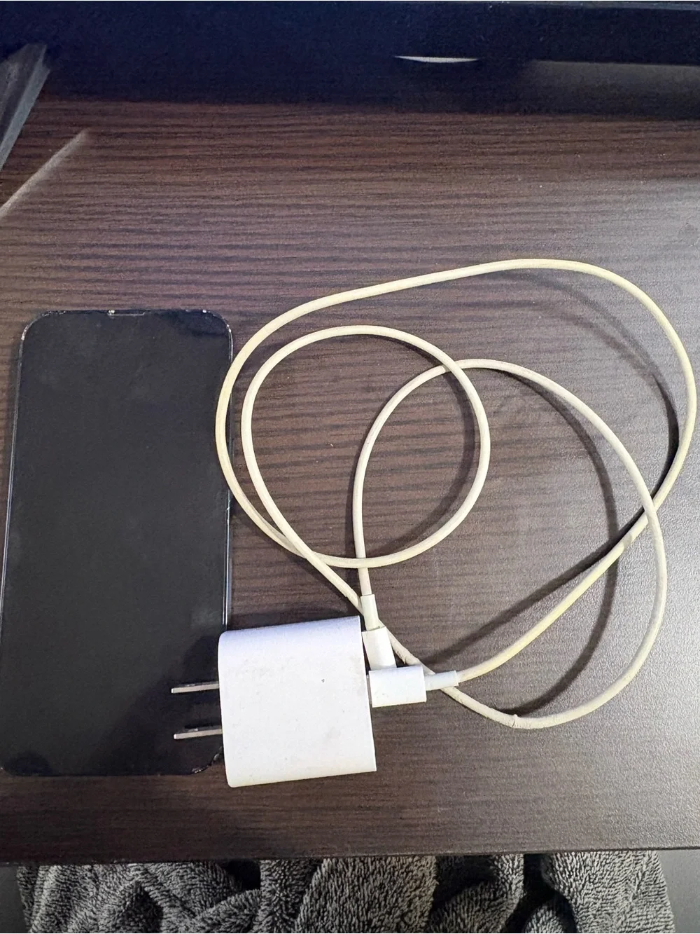 White Smartphone with White Charging Cable and Wall Adapter