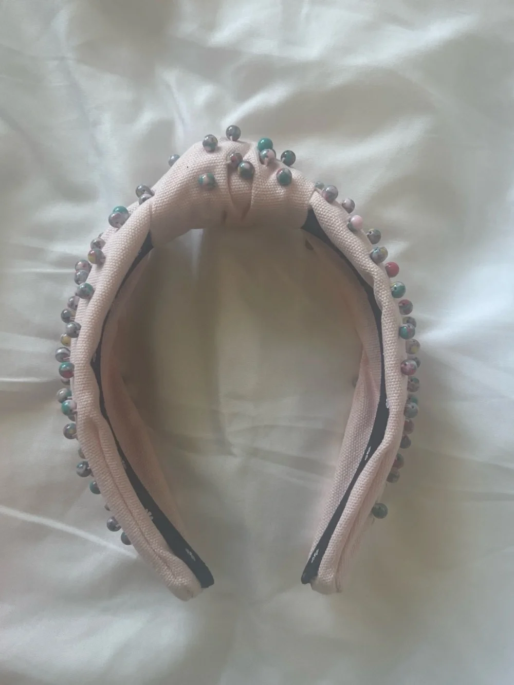 Lele Sadoughi pale pink headband with silver motifs