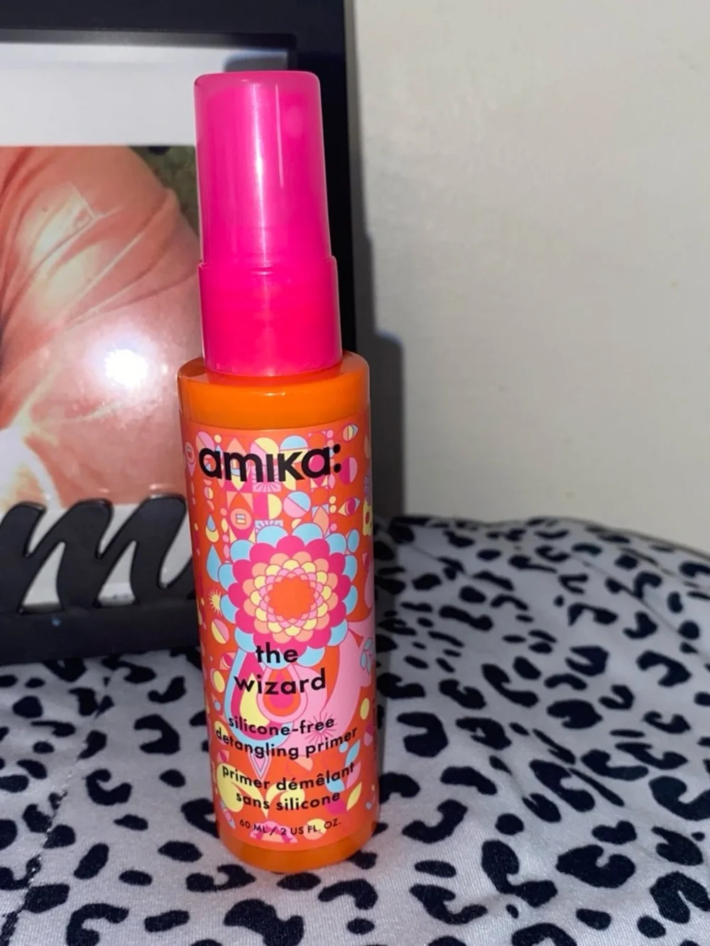 amika Bright Orange Bottle with Pink Cap Detangling Primer