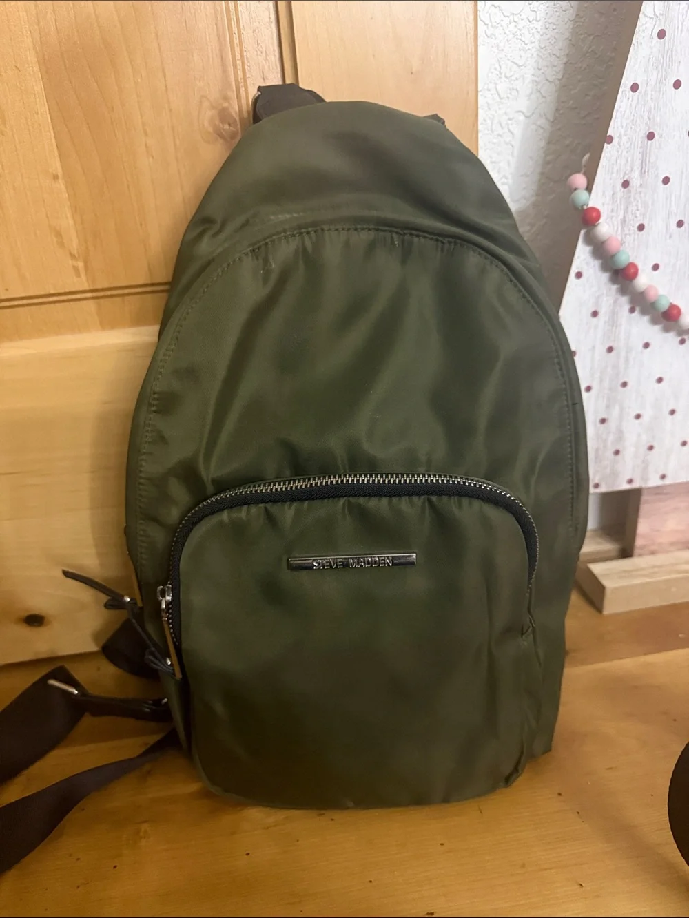 Steve Madden Olive Nylon Sling Backpack with Front Zip Pocket
