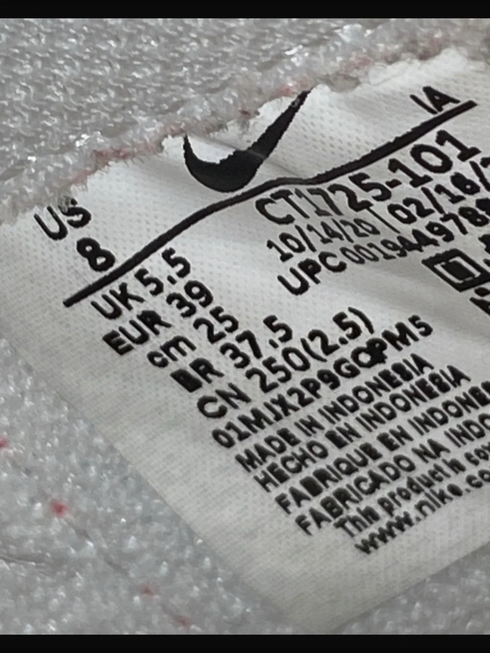 Nike White High-Top Sneakers with Red Swoosh and Gum Sole
